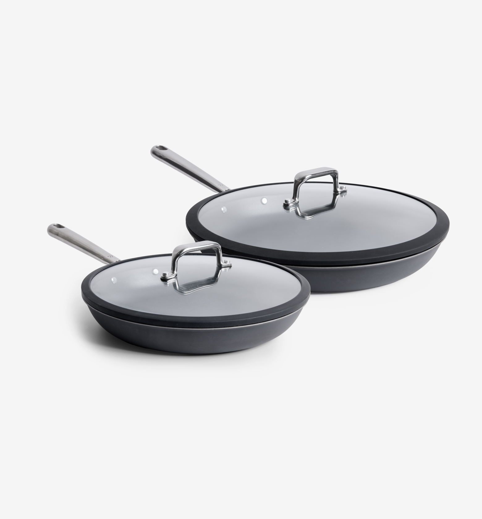 Dark gray nonstick frying pans set with glass lids and stainless steel handles, two sizes